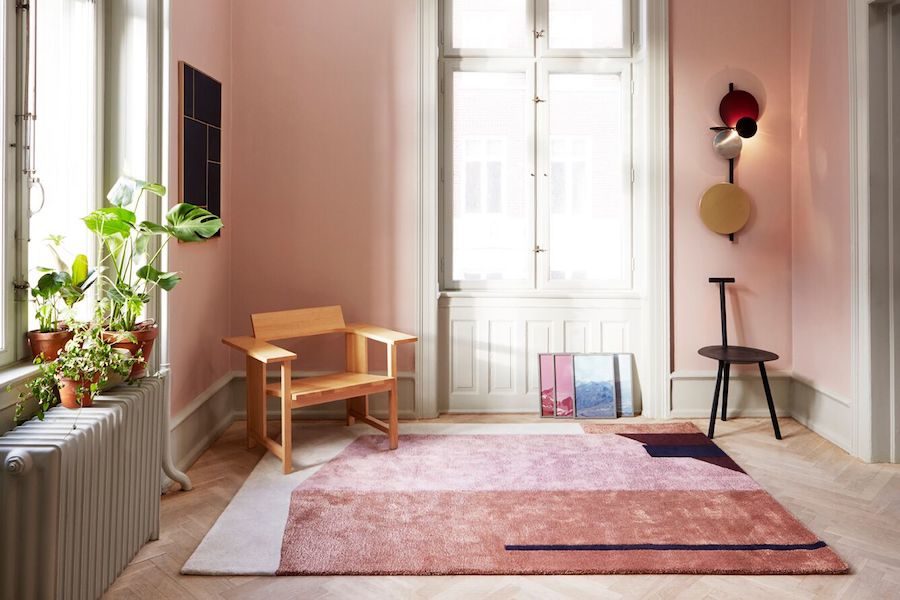 Arqui mattan i rosa toner liggandes på golvet i ett rosa rum.